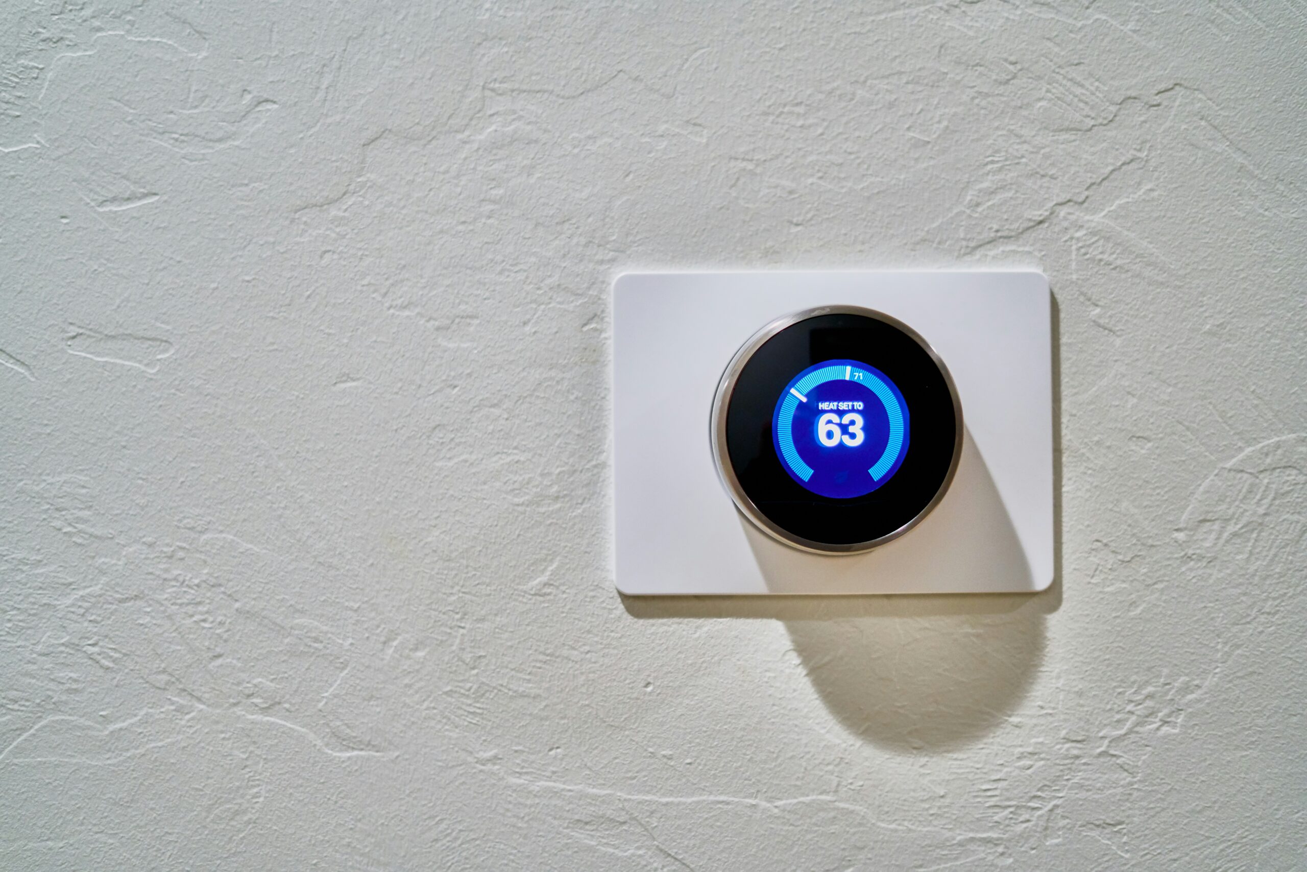 digital thermostat on wall set at 83 degrees Fahrenheit 